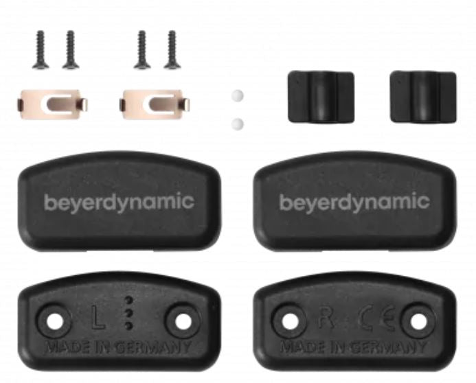 A repair kit for sliders, consisting of various black plastic parts and metal screws, with the brand name 'beyerdynamic' visible on the components.