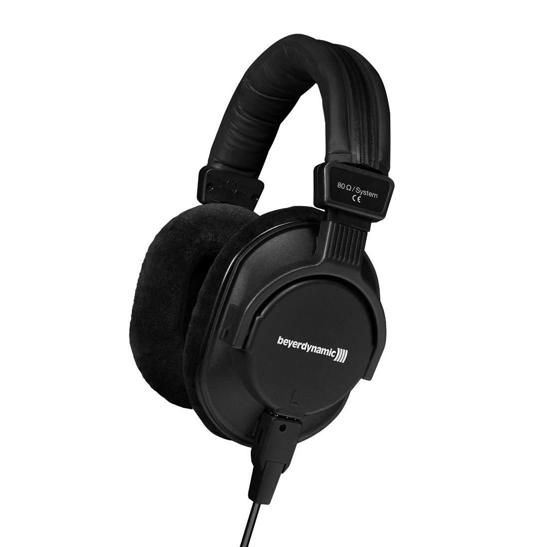 A black over-ear, closed-back, professional monitoring headphone with a wired connection and a golden combi 1/4"/mini jack plug.